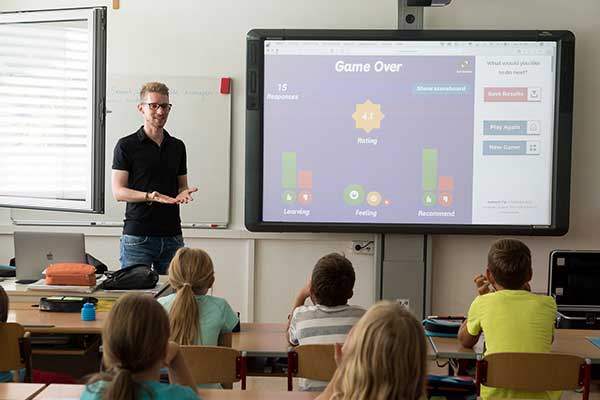 teacher at the front of an elementary school class